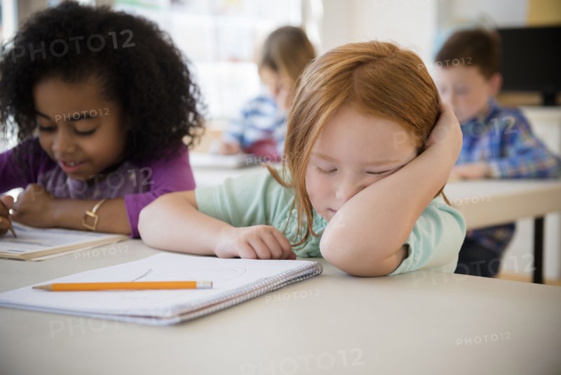 Frustrated student working in classroom