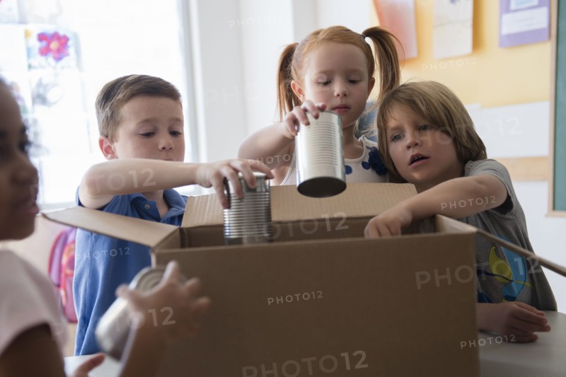 Students donating canned goods in classroom