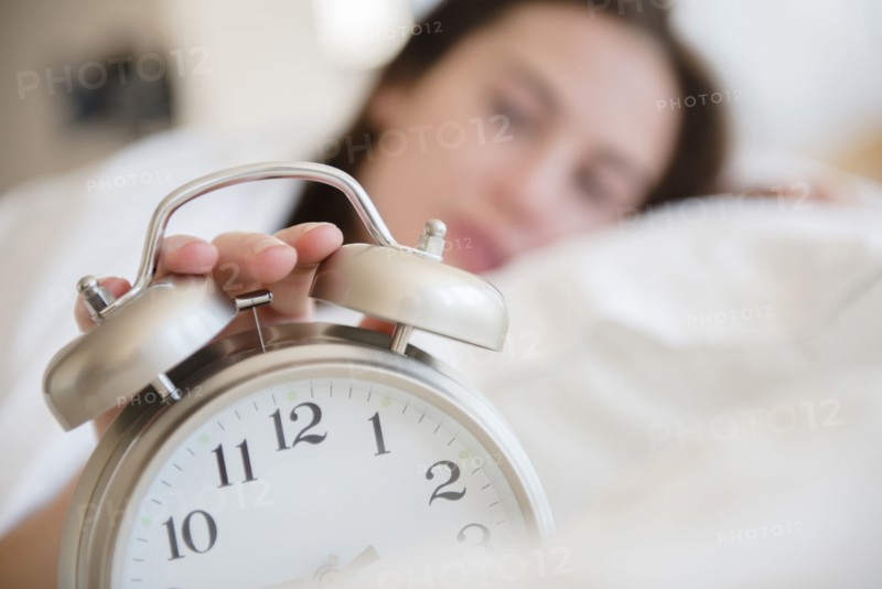 Native American woman turning off alarm
