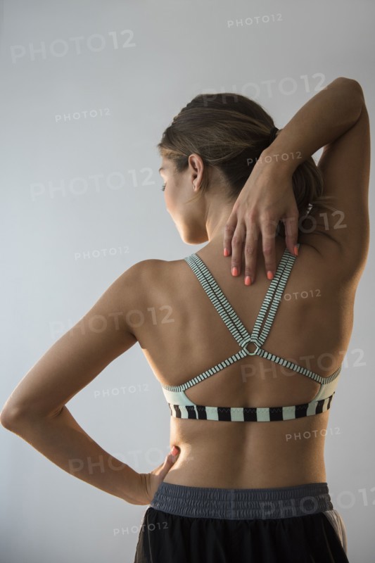 Mixed race woman stretching