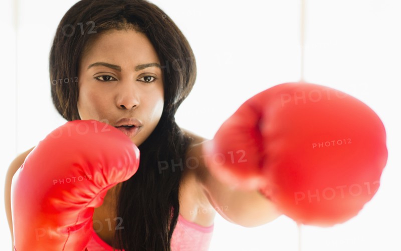 Mixed race boxer punching