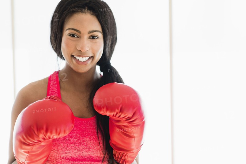 Mixed race boxer wearing boxing gloves