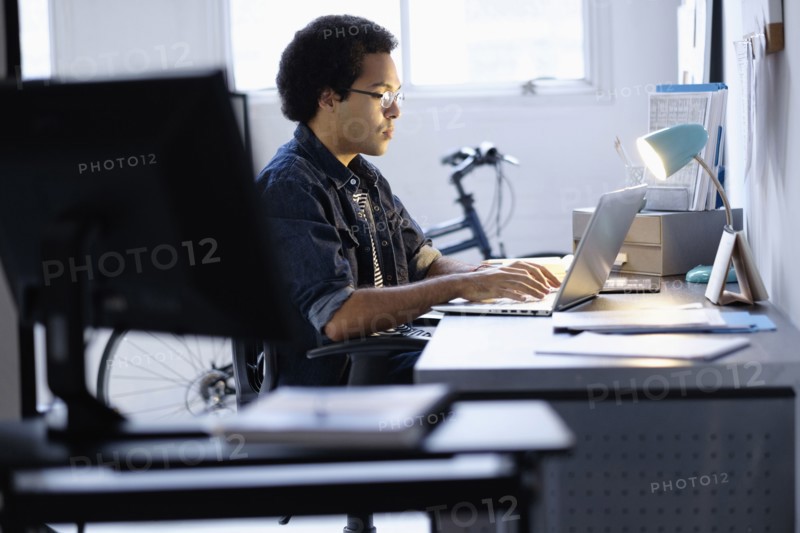 Mixed race businessman working in office