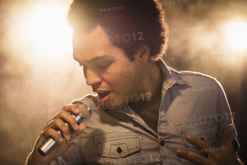 Mixed race singer performing on stage
