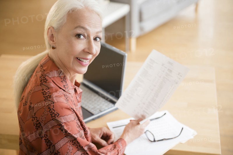 Caucasian woman paying bills on laptop