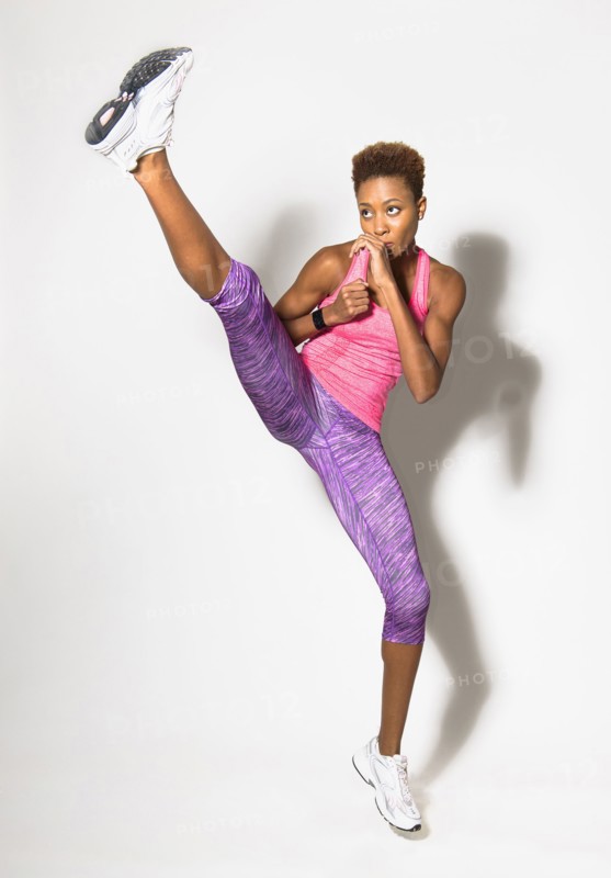 Mixed race athlete kicking