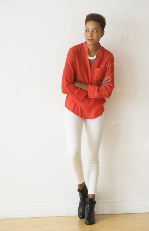 Mixed race woman standing with arms crossed