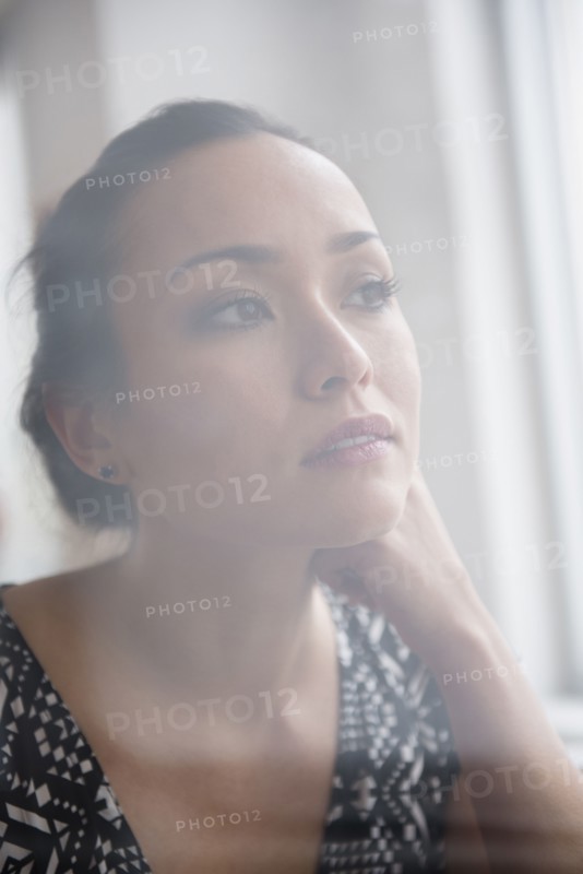 Tranquil woman looking out window