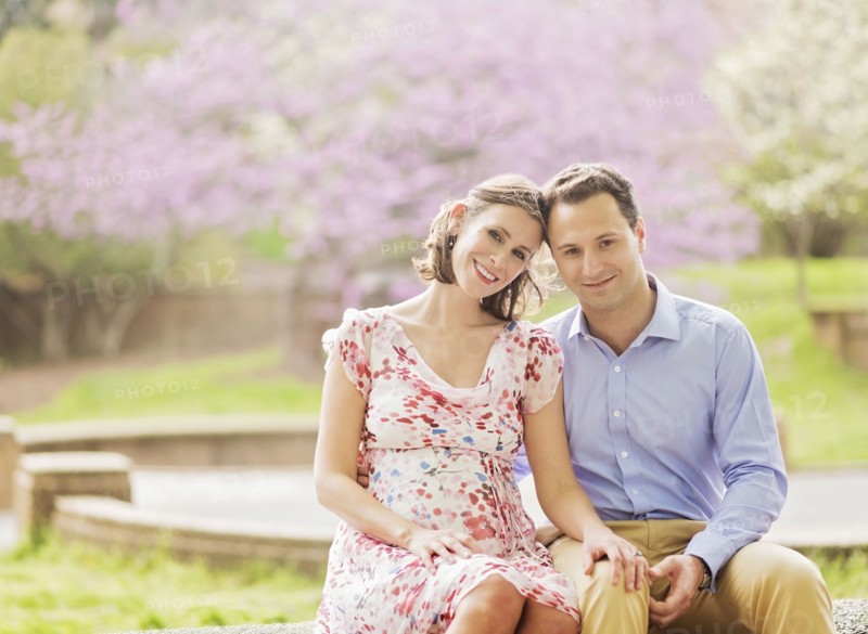 Pregnant Caucasian couple smiling outdoors
