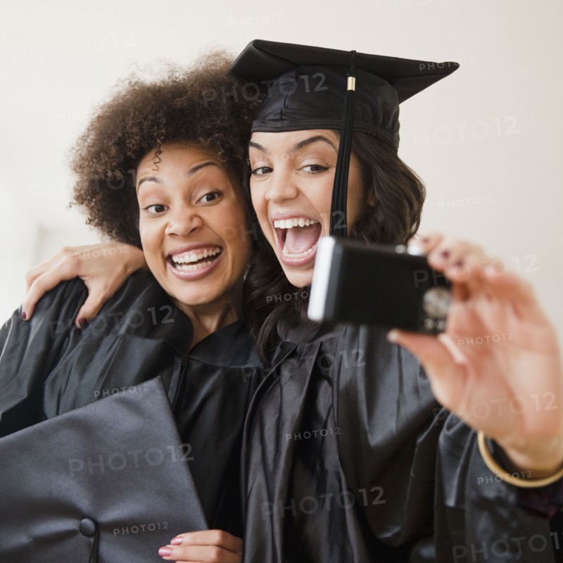 Graduating friends taking self-portrait