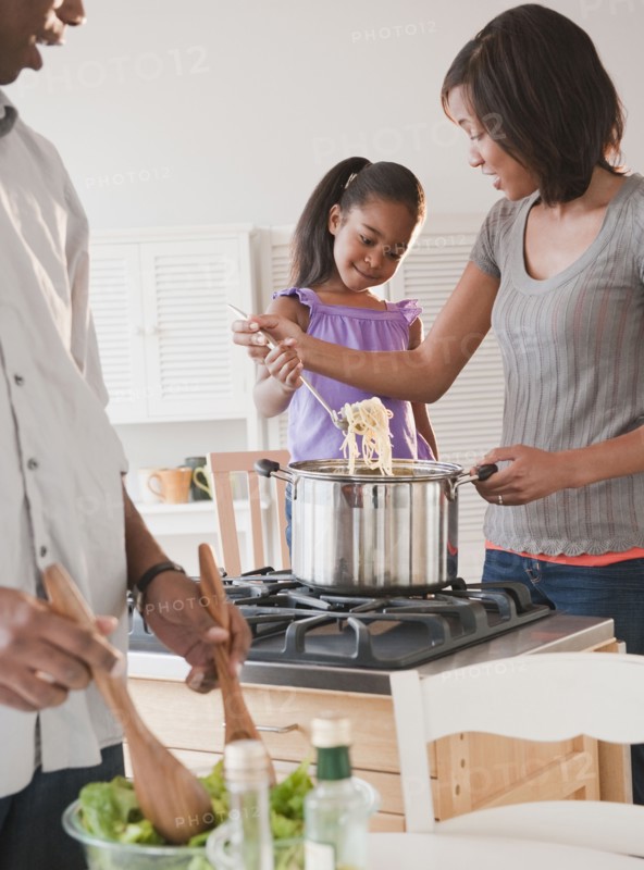 African American mother and daughter preparing dinner