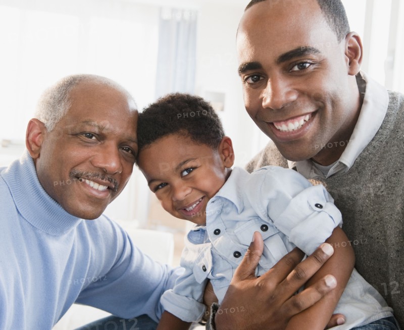 African American grandfather smiling with son and grandson