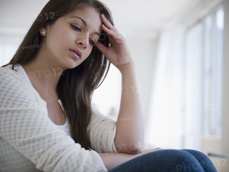 Disappointed Indian woman with head in hands