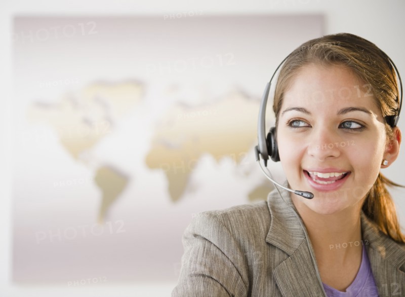 Indian businesswoman talking on headset in office