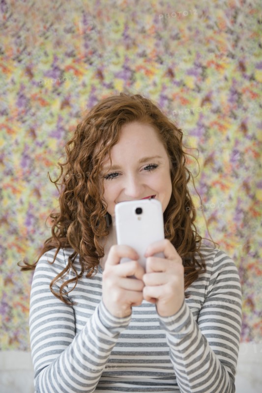 Caucasian woman taking cell phone selfie