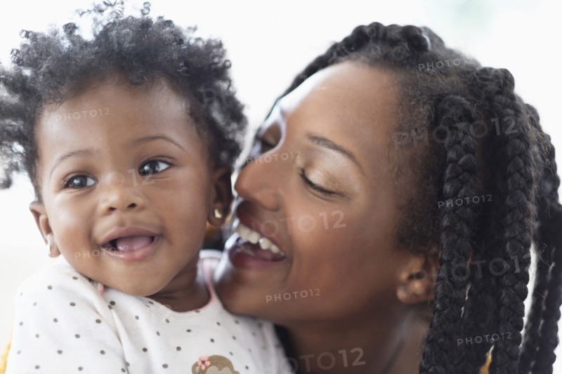 Close of  smiling Black woman and baby daughter