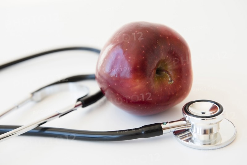 Stethoscope and red apple