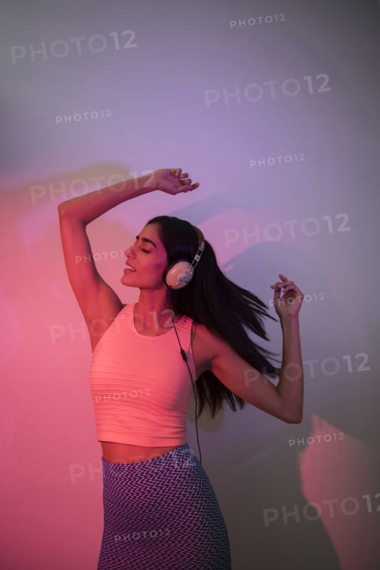 Indian woman dancing near wall casting shadow