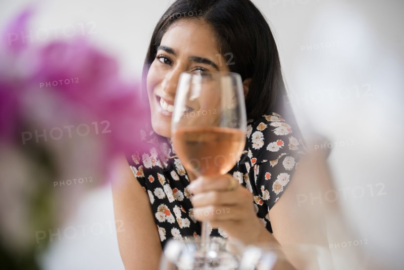 Indian woman toasting with wine