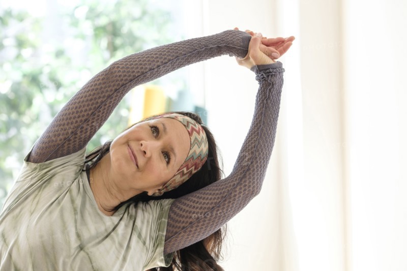 Hispanic woman stretching arms