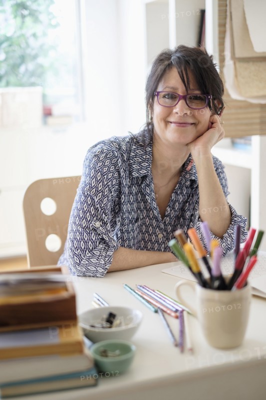 Hispanic woman smiling in home office