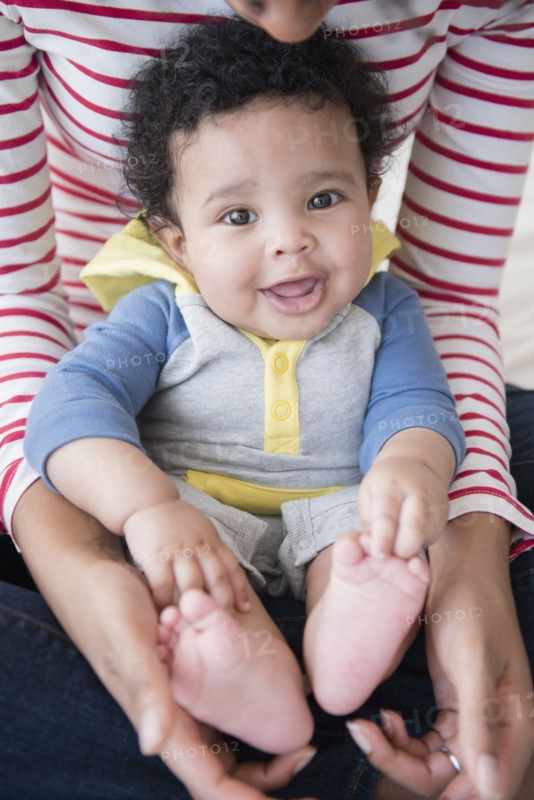 Mother holding baby son in lap