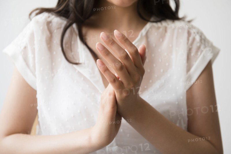 Hispanic woman rubbing hands