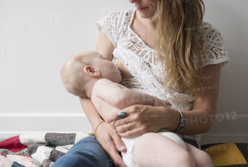 Caucasian mother breastfeeding baby son
