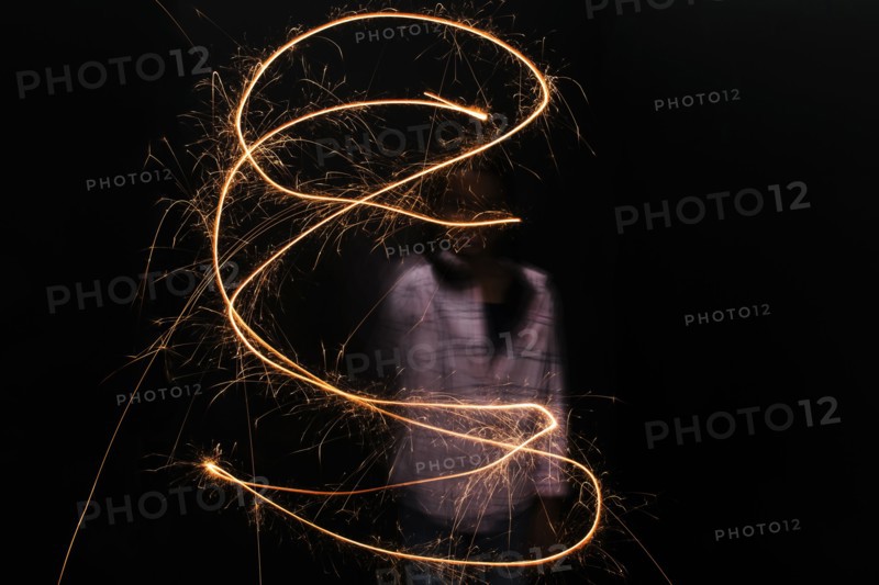 Mixed Race girl twirling sparkler