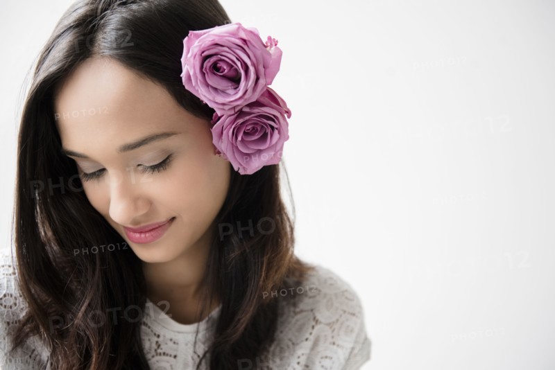 Mixed Race woman with roses in hair