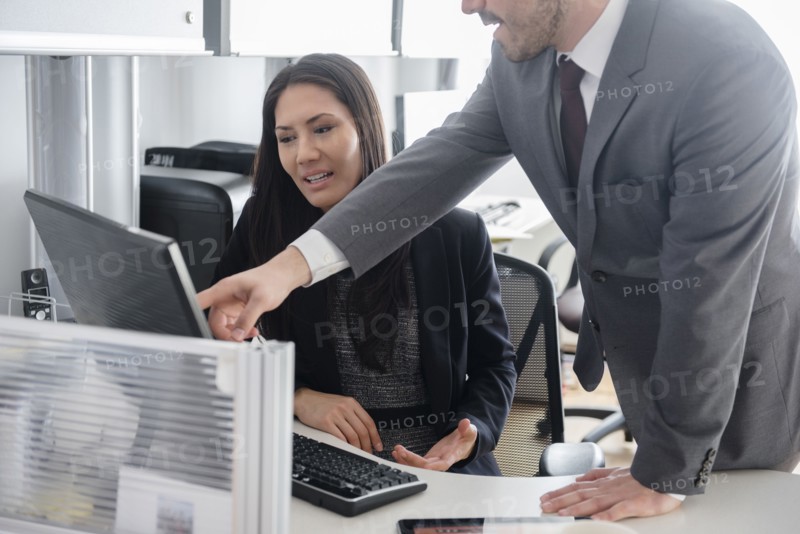 Business people talking in office using computer