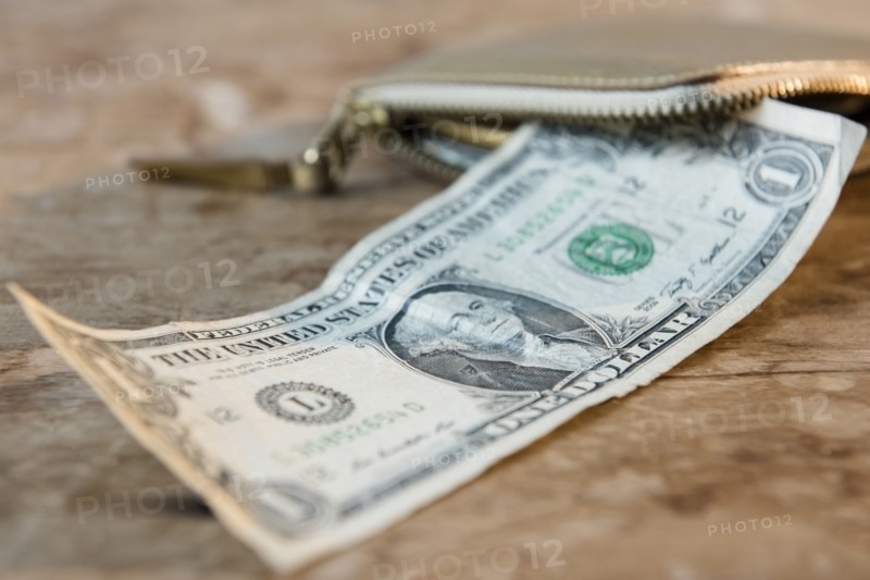 Close up of dollar on wooden table near wallet