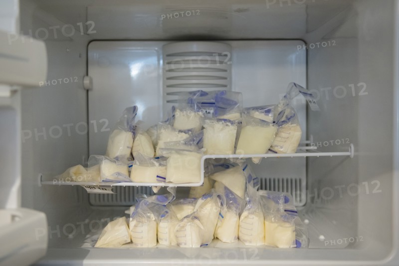 Bags of frozen breast milk in freezer