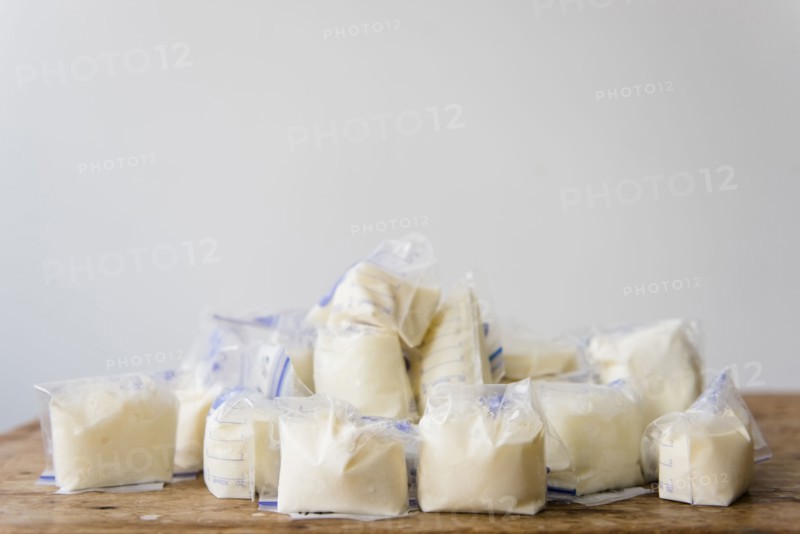 Bags of frozen breast milk on table