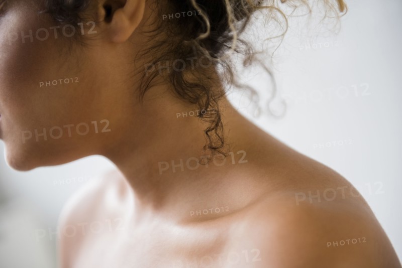 Neck and bare shoulders of Mixed Race woman