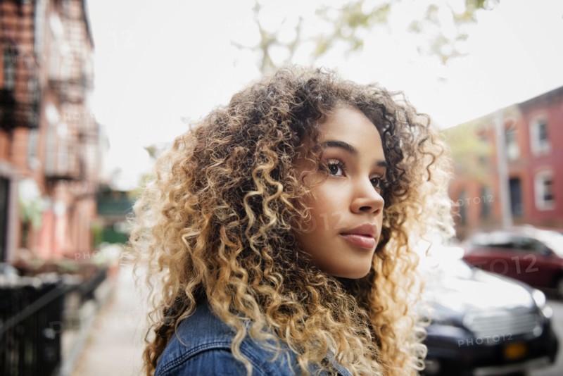Pensive Mixed Race woman in city