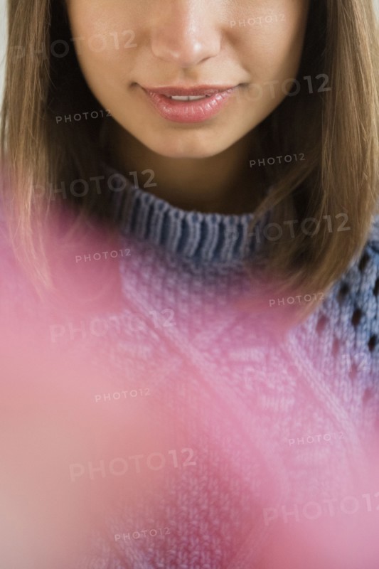 Lips of Mixed Race woman wearing blue sweater