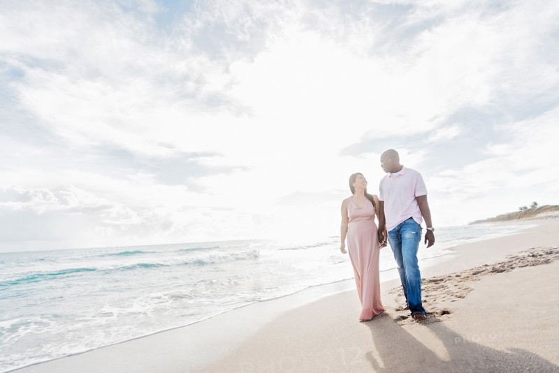 Couple holding hands walking on beach