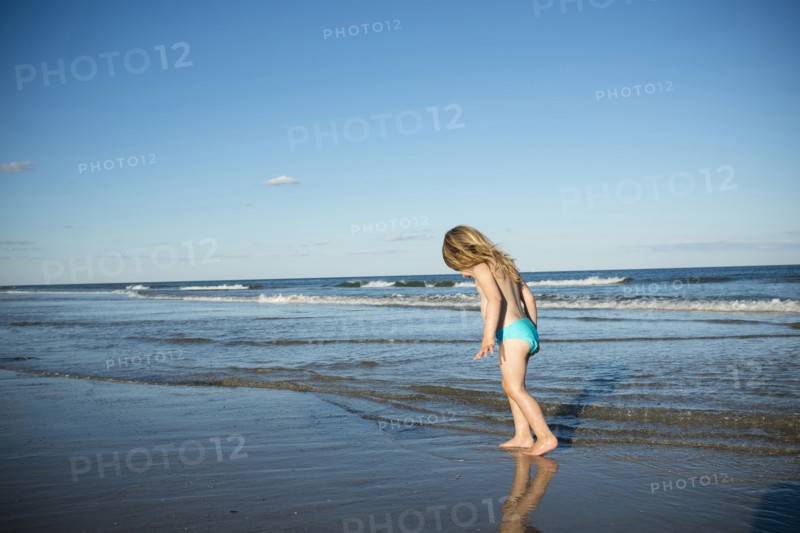 Caucasian girl walking on beach