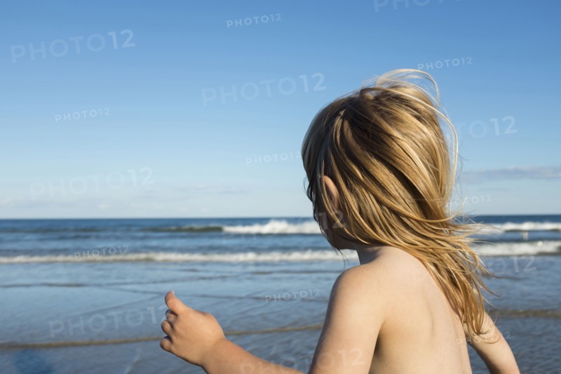 Wind blowing hair of Caucasian girl on beach