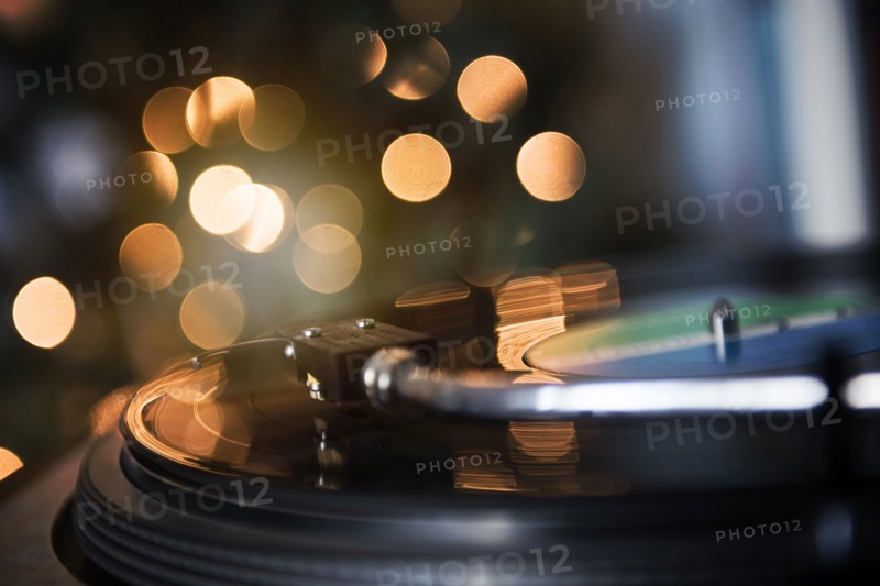 Close up of tonearm on spinning record player