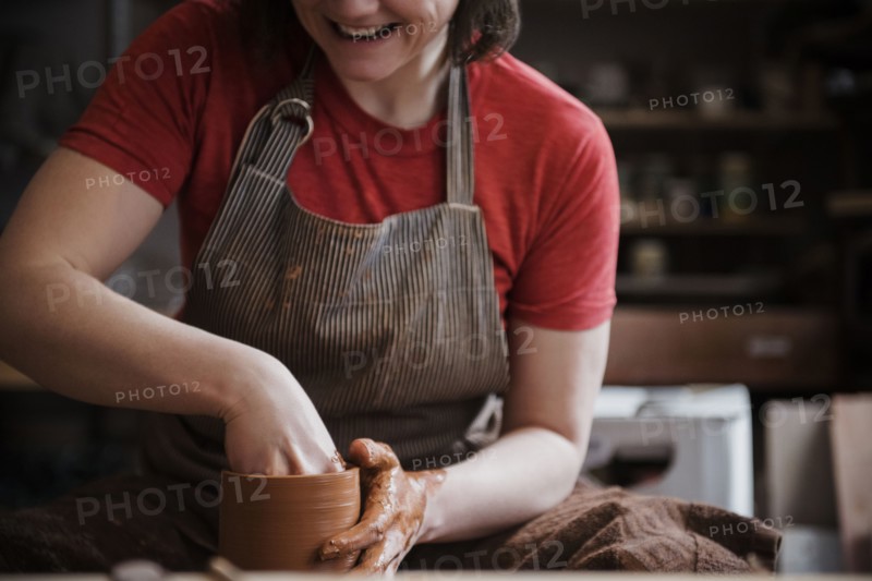 Caucasian woman shaping pottery clay