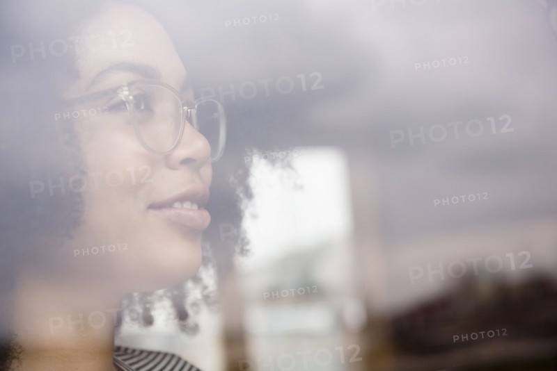 Smiling African American woman behind window