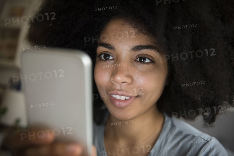 African American woman texting on cell phone