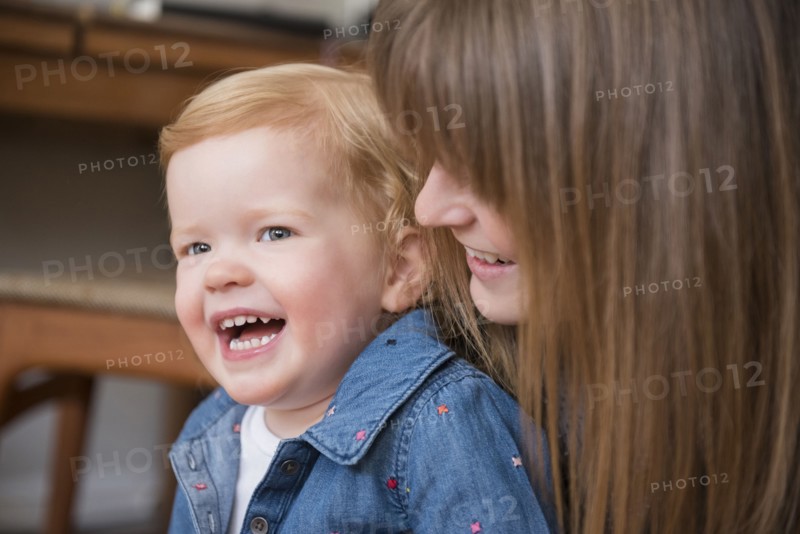 Laughing Caucasian mother and daughter