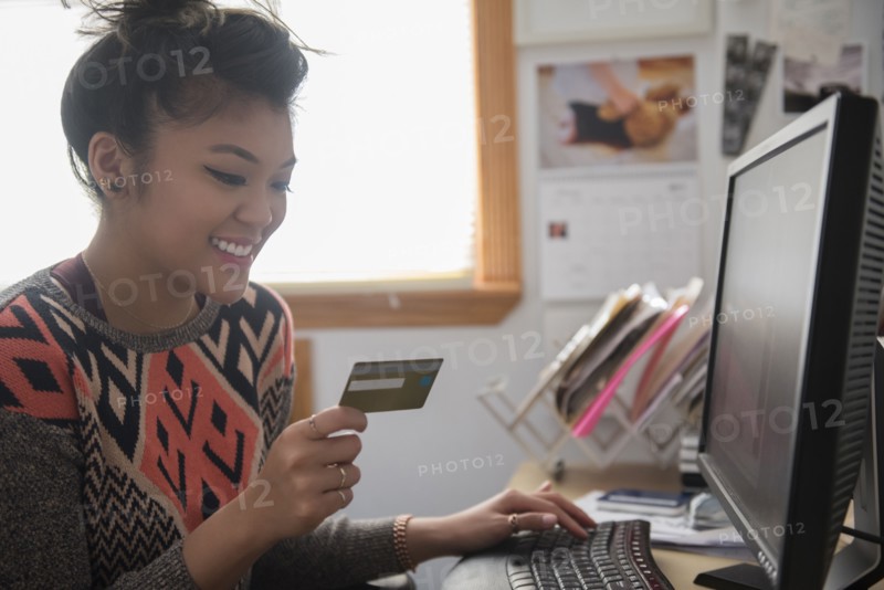 Mixed Race woman online shopping using computer