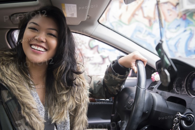 Portrait of smiling Mixed Race woman driving car