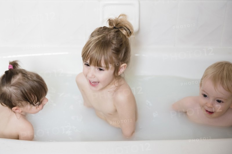 Smiling Caucasian boy and girls in bathtub