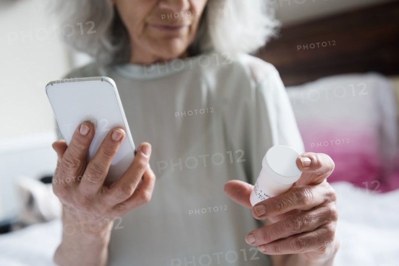 Older woman checking prescription with cell phone
