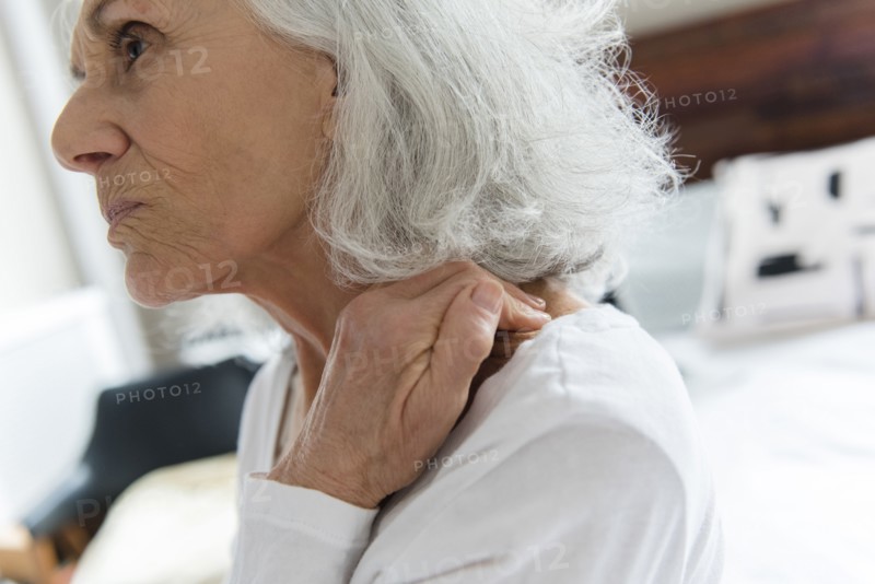 Older woman rubbing the neck